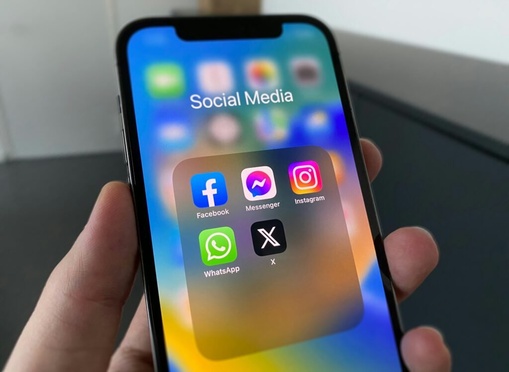 Social media marketing agency concept showing Facebook, Messenger, Instagram, and WhatsApp app icons for brand engagement.